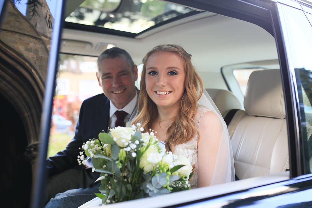bridal car with bride and father arrive at St Michael's church in Camberley