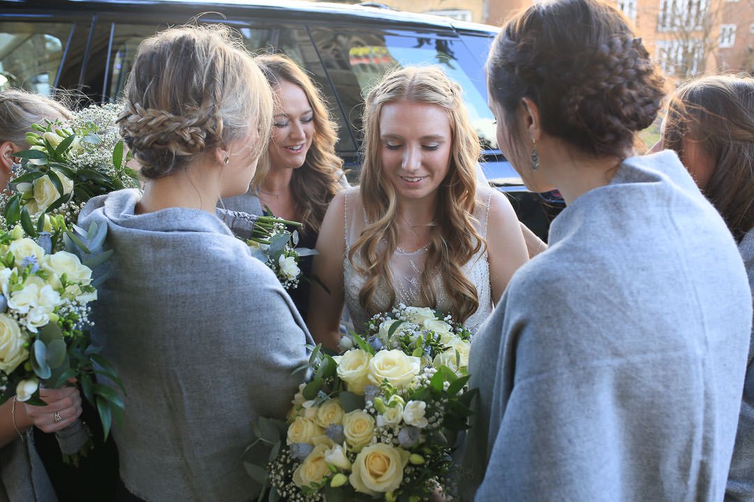 bridesmaids pray for the bride at St Michael's church in Camberley