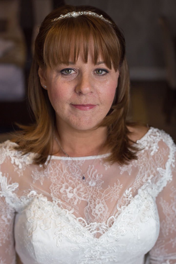 Bridal portrait with her bouquet at Oakley hall in Hampshire