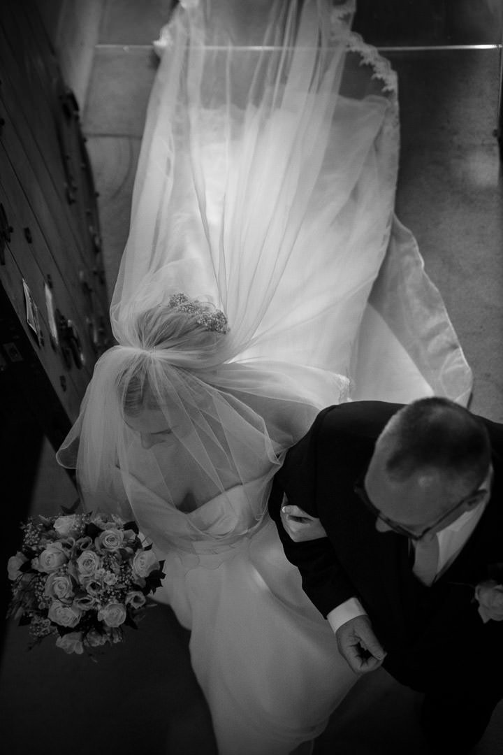 Bride walks down the aisle at St Leonard's church in Woodcote in Berkshire
