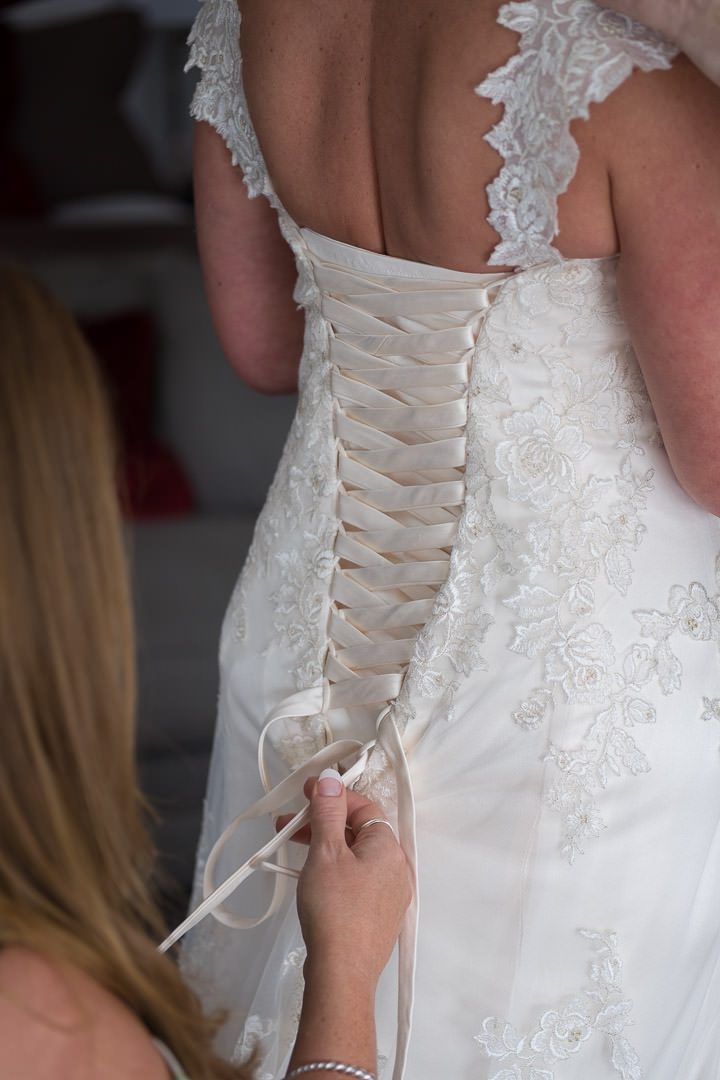 Wedding dress being laced up at Barnett Hill Hotel