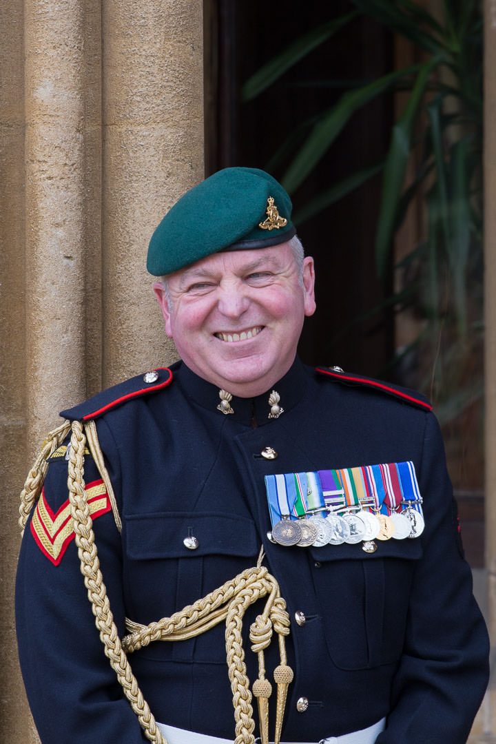 the smiling groom, wearing military dress