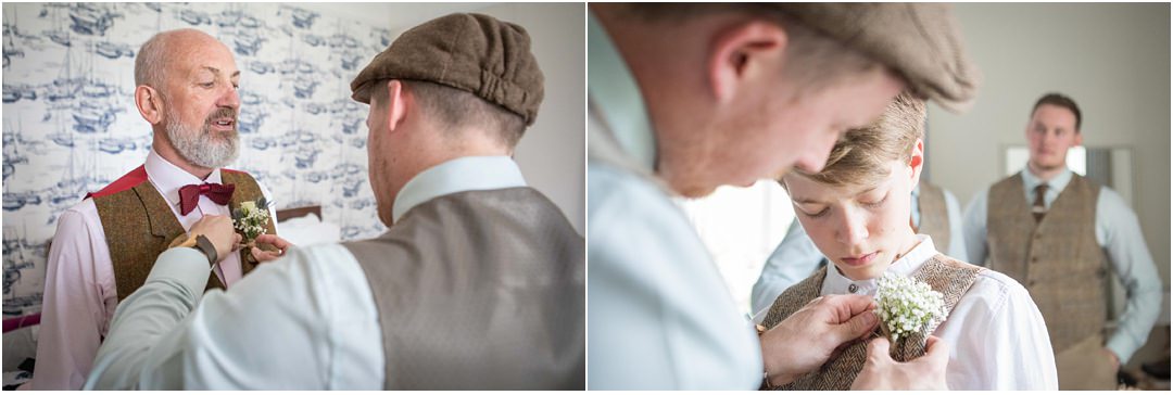 The groom and groomsmen pin their buttonholes for each other
