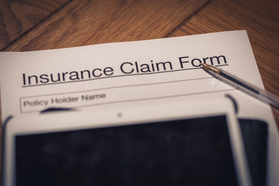 insurance claim form with pen and ipad