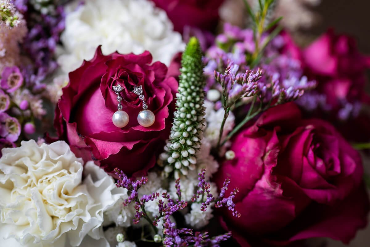 Detail ring shot with bouquet at the Elvetham wedding