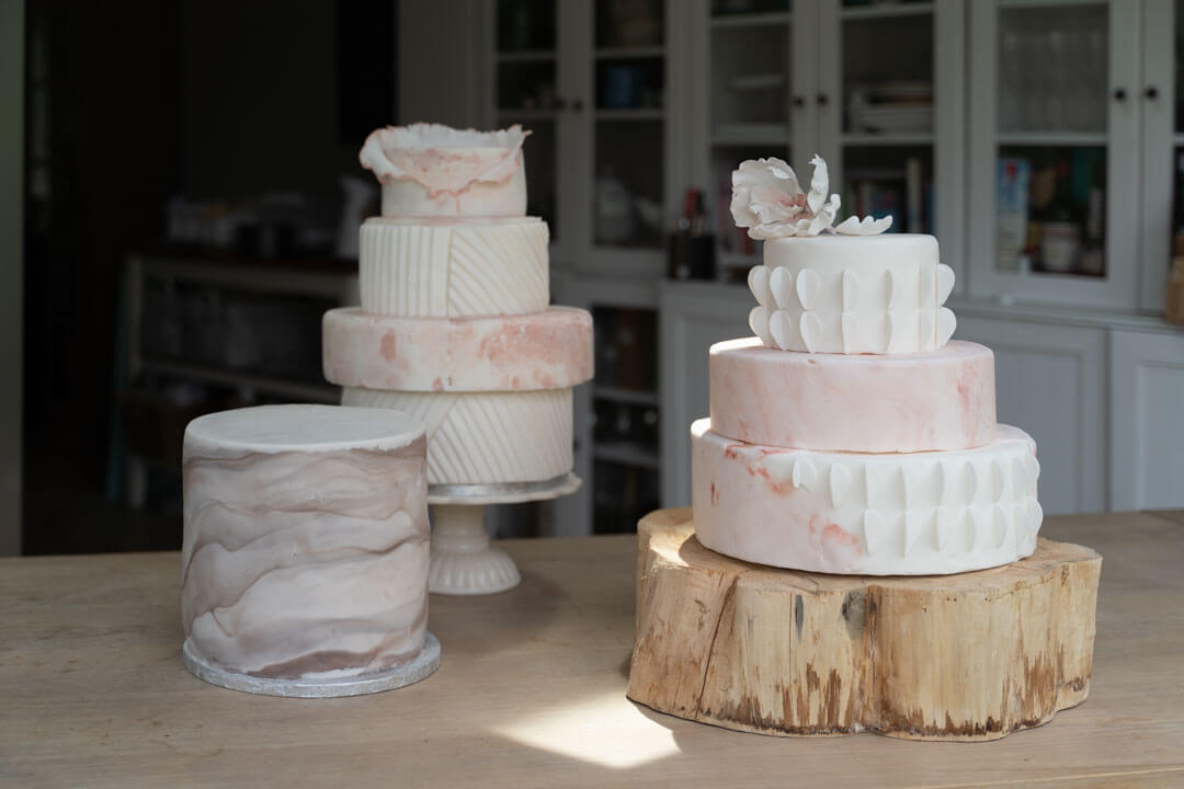 three different types of wedding cakes on a wooden table