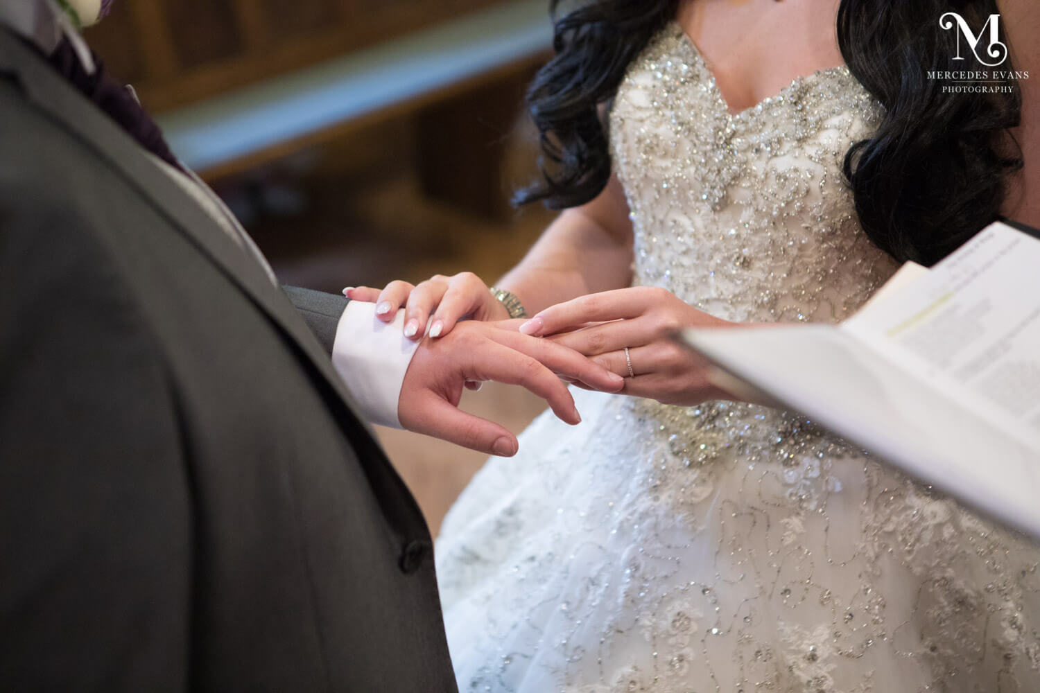 The bride puts a wedding on to the groom's finger during the wedding ceremony