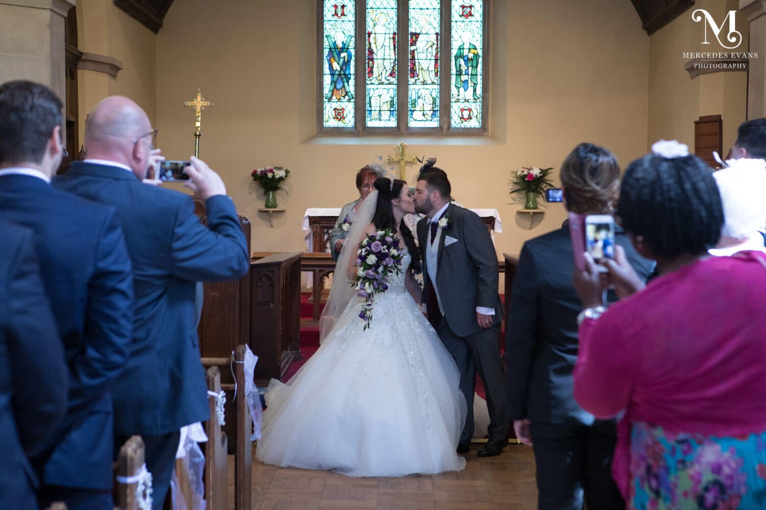 The newly weds kiss in St Andrew's church in Frimley
