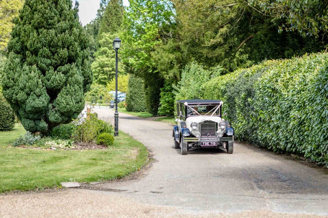the vintage Viscount wedding car arrives at Highfield Park in Hampshire