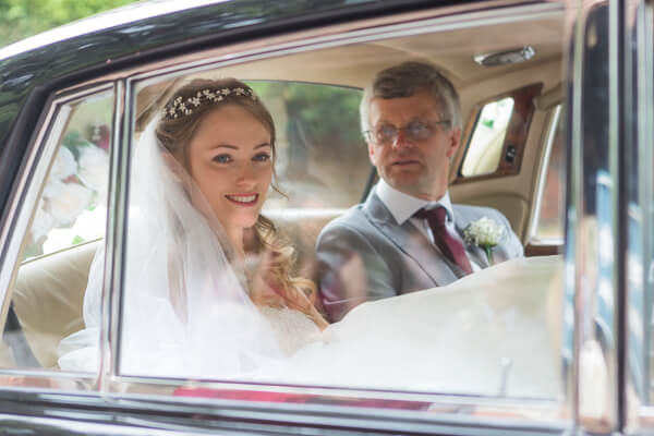 Bride and her father arrive in the wedding car at Horsell Parish Church 