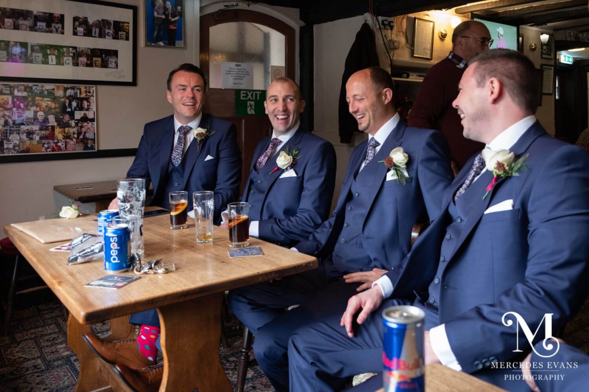 The groom and his groomsmen enjoy a drink in the pub before the wedding ceremony