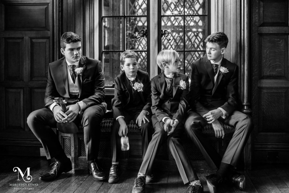 teenage ushers sit waiting in the Oak room at the Elvetham before the start of the wedding