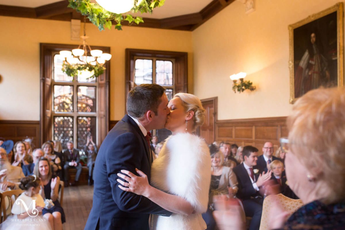 the happy couple enjoy their first kiss during the wedding ceremony at the Elvetham