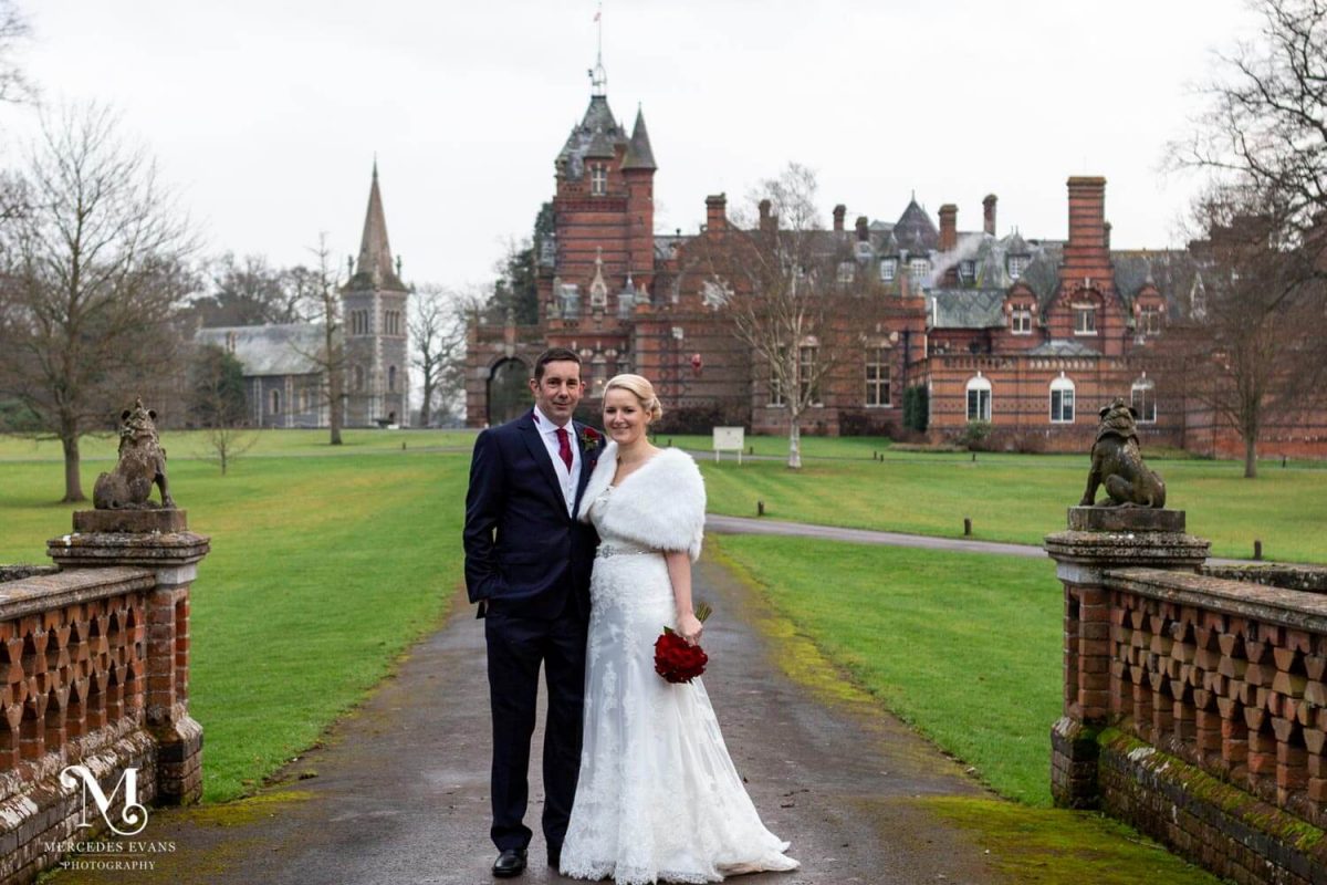 The bride and groom stand together in front of the Elvetham