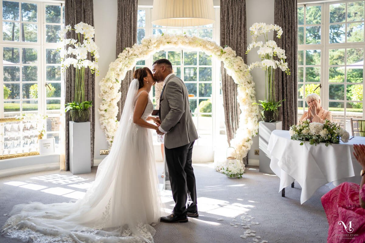 the bride and groom share their first kiss during their wedding at gorse hill hotel