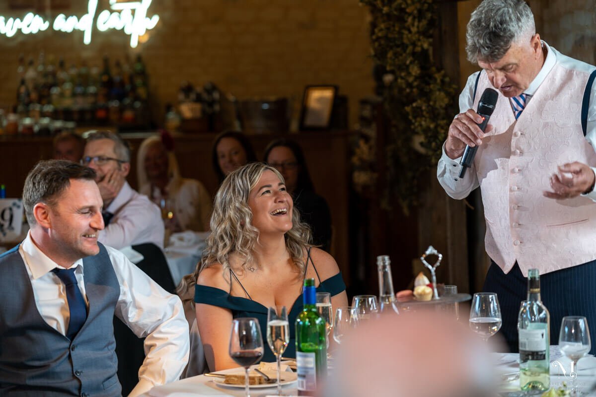 guests laugh at the Father of the Groom's wedding speech
