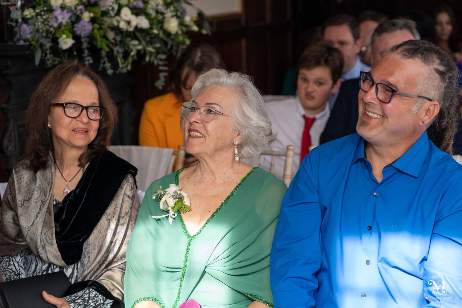 wedding guests smile during the ceremony