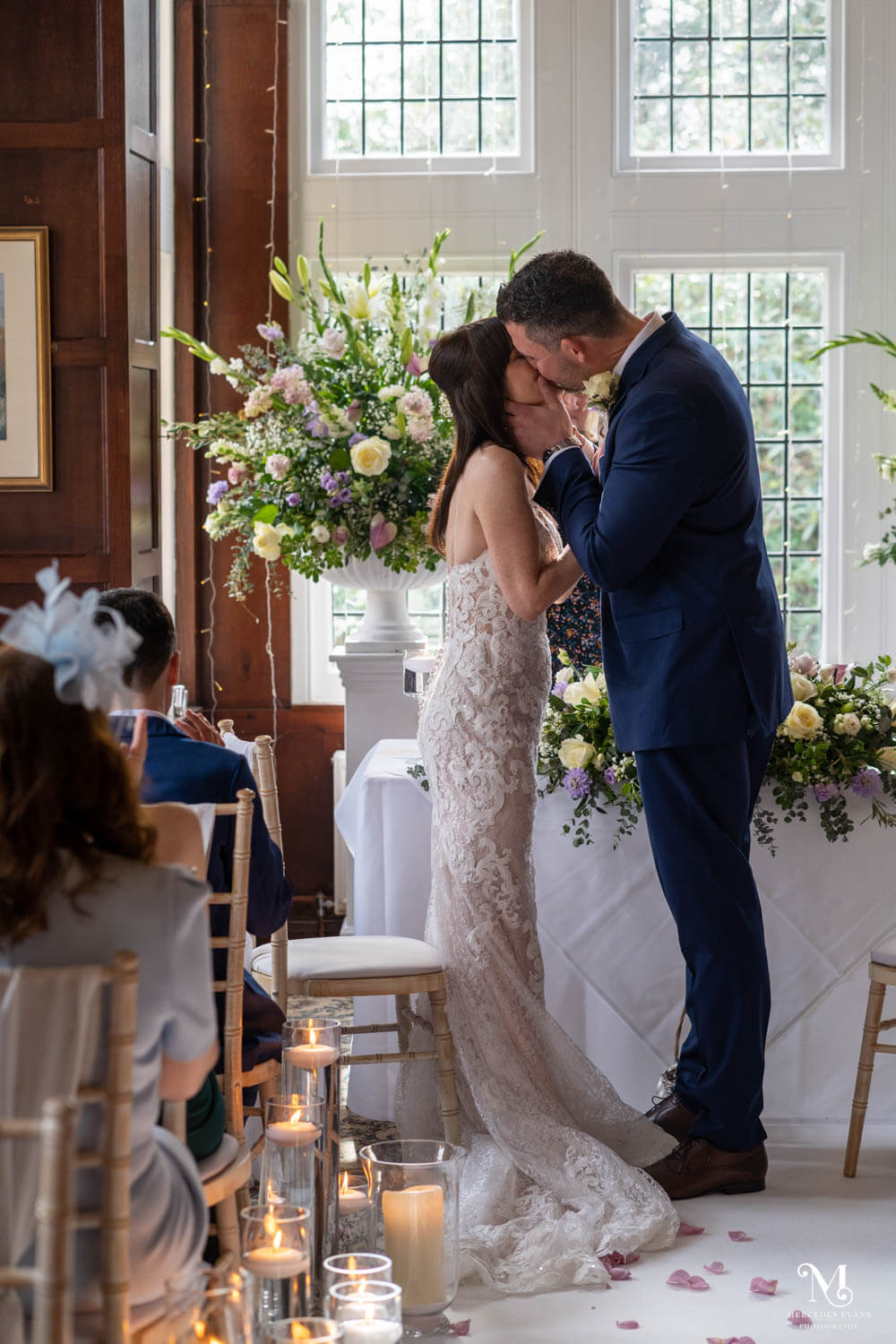 the bride and groom enjoy their first kiss during their wedding ceremony in the Oak room at Cantley House Hotel