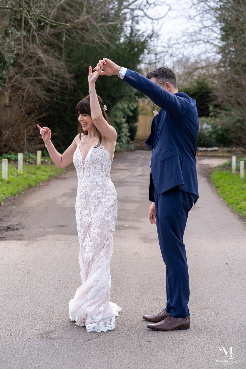 The groom twirls his dancing bride on the drive at cantley house