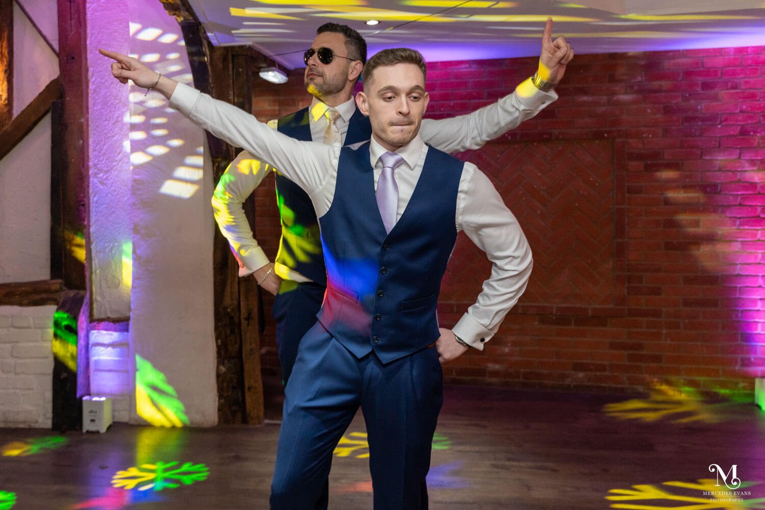 the groom and groomsman do a dance routine on the dance floor with coloured lights
