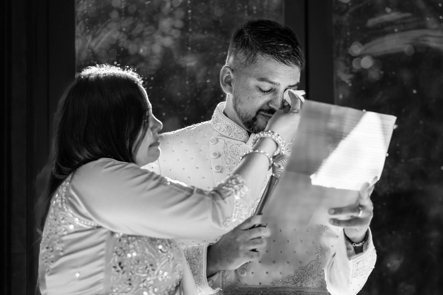 mother wipes away her son's tears during his wedding speech