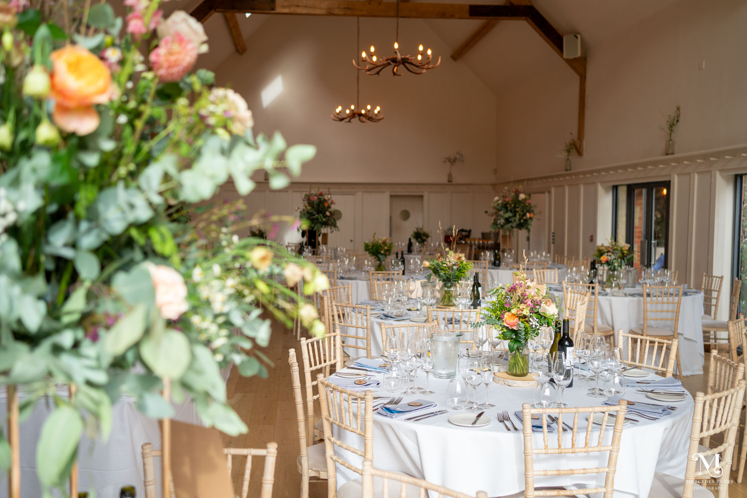 the high-vaulted hall set for the wedding breakfast at Millbridge court, with round tables
