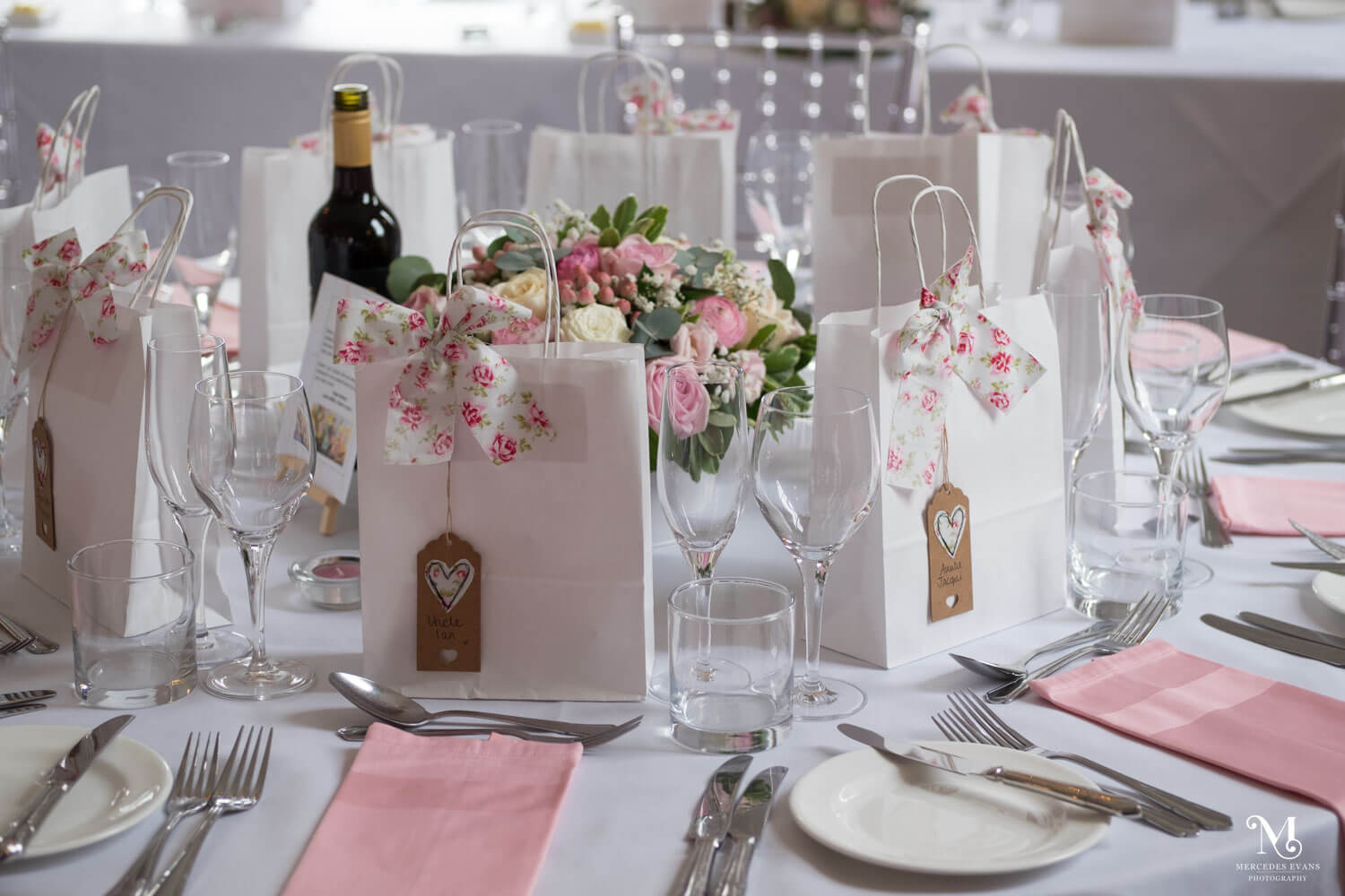a close up of a wedding breakfast table set up with a pink and white theme