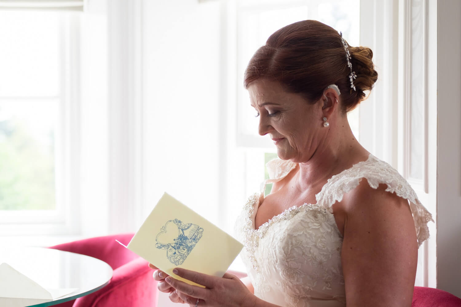 the bride sits and reads a card from her husband-to-be