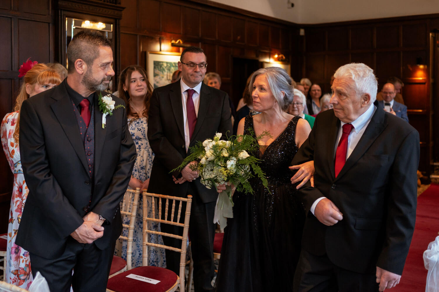 the bride and groom share a first look as she arrives at the top of the aisle with her father