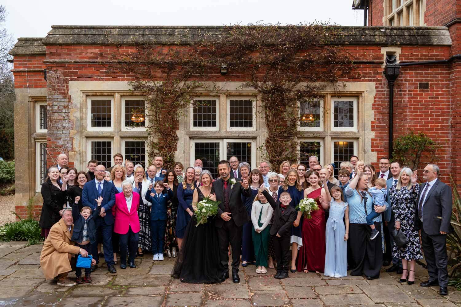 whole wedding group photo outside the oak room at cantley house