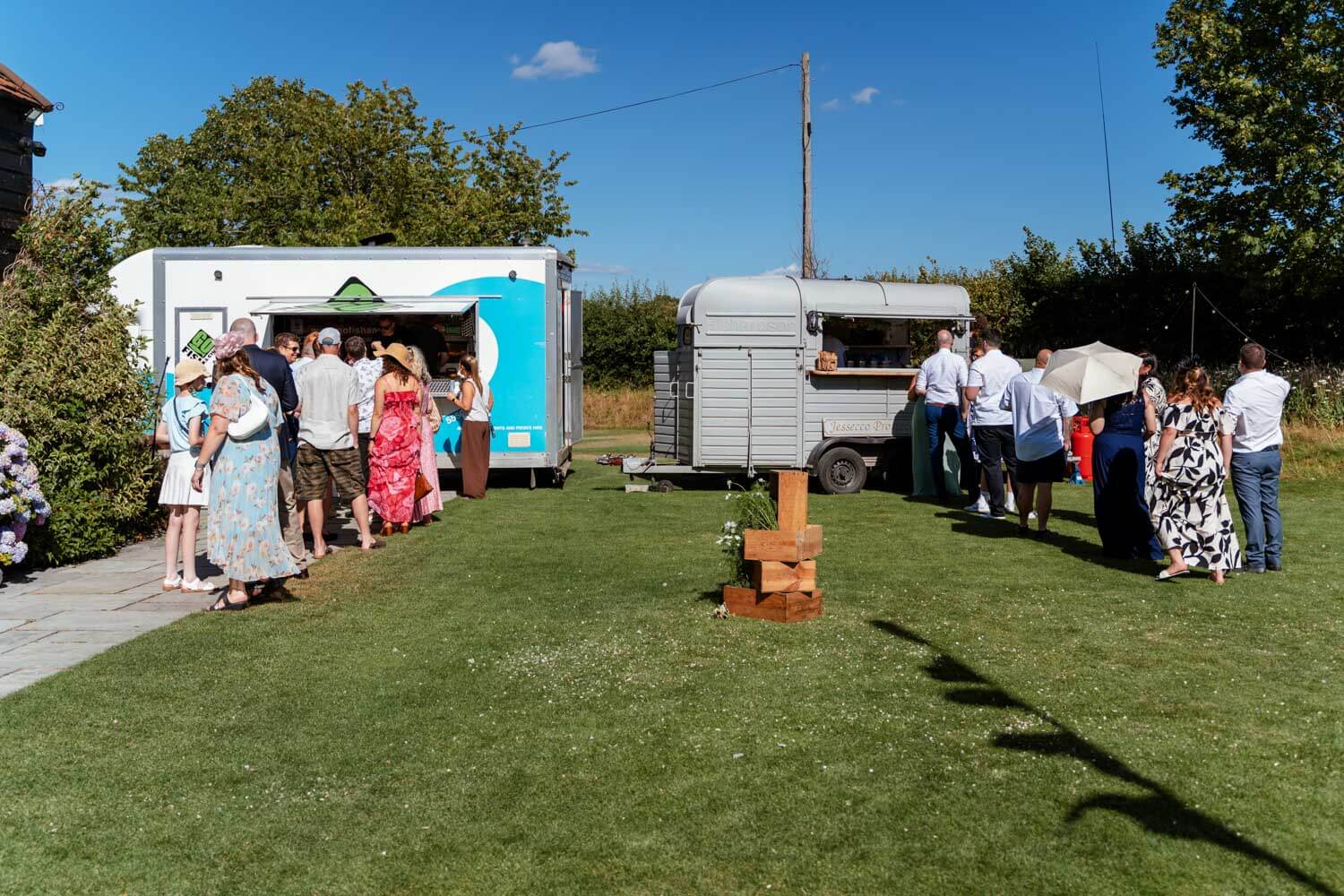 Guests queue at the food trucks on the lawn during the reception.